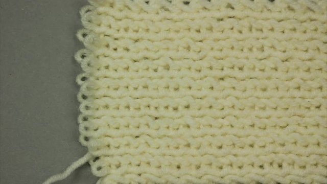 Dissolving knitted background. Place for text. Stop motion