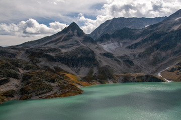 View of the Alpine glacier swaying into the mountain turquoise lake