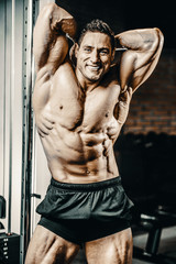 Fototapeta na wymiar Bodybuilder strong man pumping up abs muscles
