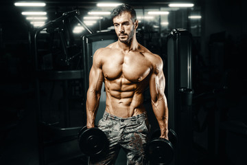 Naklejka na ściany i meble Bodybuilder athletic man workout muscles exercise.