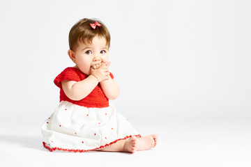 A baby in a red dress