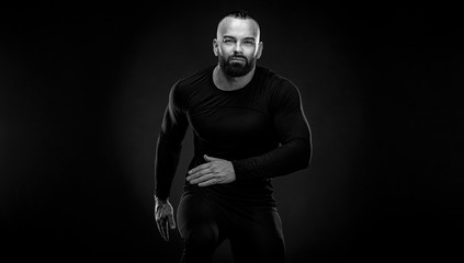 Fototapeta na wymiar Muscular young fitness sports man athlete in compression garment. Workout in gym