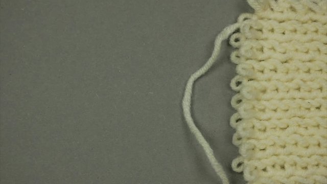 Knitted surface. Thread knits loops forming a background. Stop motion