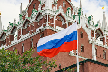 Russian flag waving on background of Kremlin tower