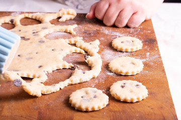 Mujer amasando masa para galletas de chocolate en tabla de madera con rodillo masa en bola