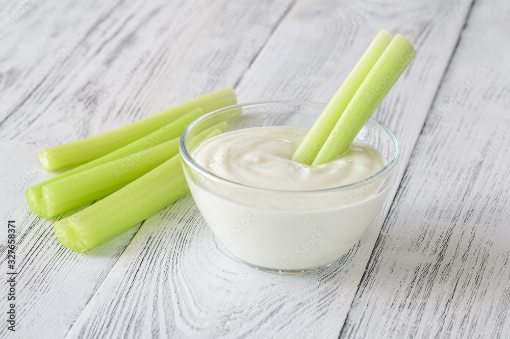 Wall mural celery stalk dipped in yogurt