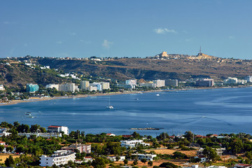 Fototapeta na wymiar The city and the beach on the bay on the island of Rhodes.