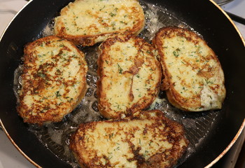 Texture of delicious white bread croutons with dill fried on a hot pan in boiling oil. 