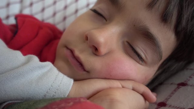 4K Close up face on hands sleeping restless child