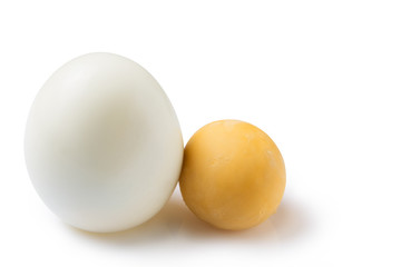 peeled boiled egg, on a white background, lies next to a round yolk, food concept