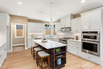 Kitchen in New Home with Large Island and Stainless Steel Appliances