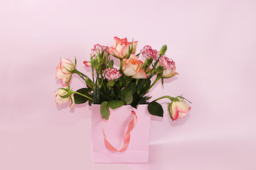 Arrangement of flowers on a pink isolated background, place for text, flat lay. Creative modern bouquet, minimal holiday and spring concept. Greeting card for Women's Day  ,happy birthday, wedding,