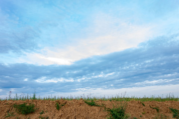 rural field and blue sky with clouds