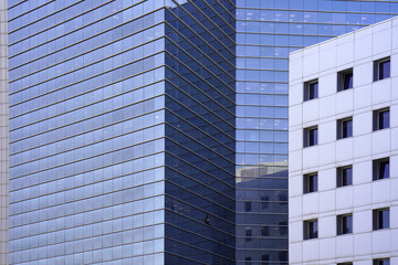 Abstract architecture. Glass blue square Windows of facade modern city business building skyscraper. The texture of the windows of the building.  