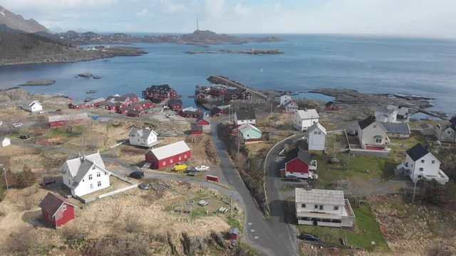 Bird s eye perspective over a beautiful Lofoten town called A with red cabin lodges at the bank of the arctic sea