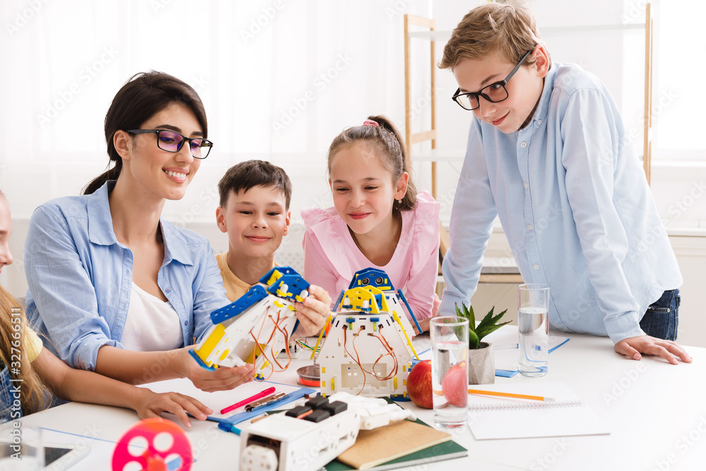 Poster process of creating. children and teacher making robot