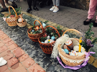 Easter baskets with stylish painted eggs, easter cake, ham,beets, butter, candle with boxwood...