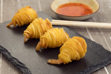 Breaded prawns with potato noodles