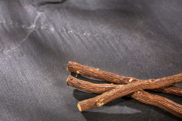 Close up of Ayurvedic herb Liquorice root,Licorice root, Mulethi or Glycyrrhiza glabra root on a wooden surface is very much beneficial for Soothes your stomach,poisoning