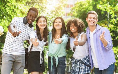 Happy Multicultural Teens Posing Together Outdoors And Showing Thumb Up