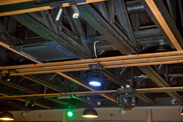 LED down light isolated on black background. Lights and ventilation system in long line on ceiling of the dark office industrial building, Restaurant Hall Ceiling construction .