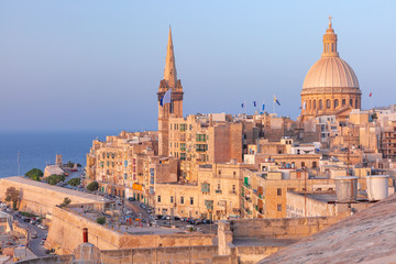 View of Old town roofs, fortress, Our Lady of Mount Carmel church and St. Paul's Anglican Pro-Cathedral at sunset , Valletta, Capital city of Malta - obrazy, fototapety, plakaty