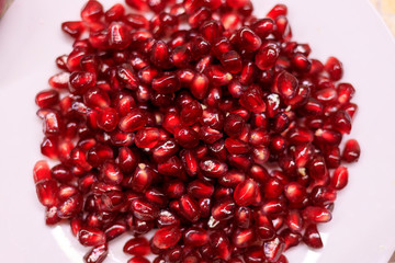 pomegranate seeds on a white plate