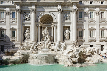 Fototapeta na wymiar The Trevi Fountain is a miracle of architecture and one of the most famous sights of Italy. In niches located on the sides of Neptune, there are allegorical figures, and on top - bas-reliefs.