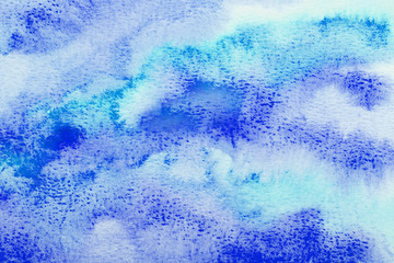 Abstract blue watercolor background. The color splashing on the paper. Hand drawn.