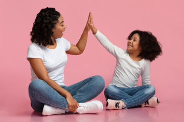 Happy Black Mom And Daughter Giving High Five To Each Other