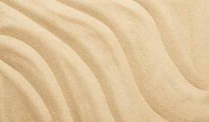 Fototapeta na wymiar Tropical sand background with sand waves. Sandy beach texture. Top view