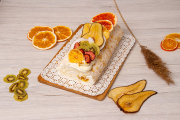 Juicy sliced meringue cake with dried fruits