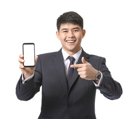 Young Asian businessman with mobile phone on white background