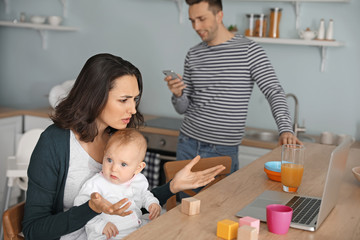 Young woman suffering from postnatal depression at home