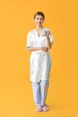 Portrait of woman with cup of coffee on color background