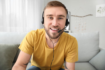 Young man using video chat at home