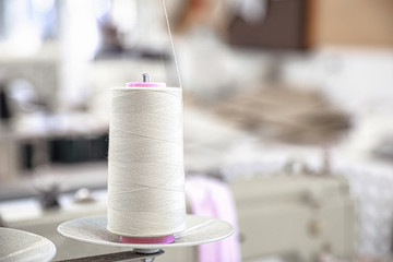 Spool of threads in tailor workshop, closeup