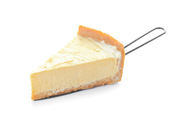 Slice of sweet tasty cheesecake on white background