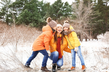 Mother with little children in park on winter day