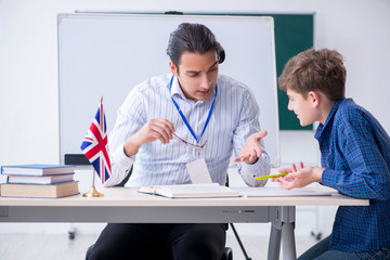 Male english teacher and boy in the classroom