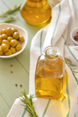 Bottle of tasty olive oil on wooden table