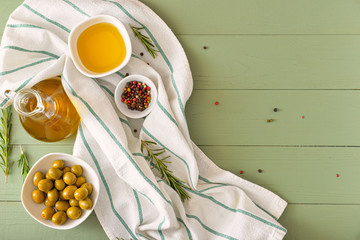 Tasty olive oil with spices on wooden table