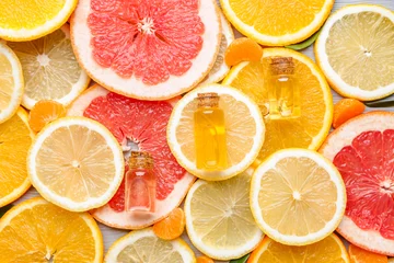 Foto op Plexiglas Bottles with essential oils on citrus fruits slices © Pixel-Shot