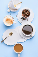 Cups of coffee on color background