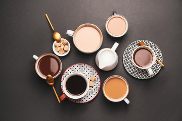 Obraz na płótnie Canvas Cups of coffee with milk on dark background