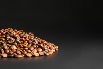 Heap of coffee beans on dark background