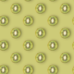 Seamless blue kiwi pattern on green background