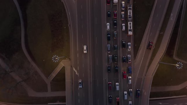 Drone flies over a freeway with high traffic at night. Big traffic jam on the bridge in Warsaw, Poland. Aerial view of expressway, top view, traffic ring road is an important infrastructure in Poland.