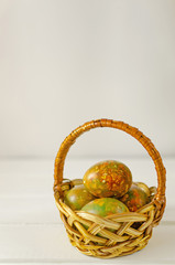 trendy modern easter multicolored, originally painted, marble eggs in a basket on a light...