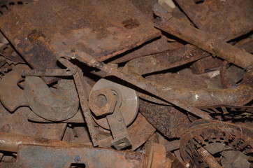 Rusty scrap metal lies in bulk.